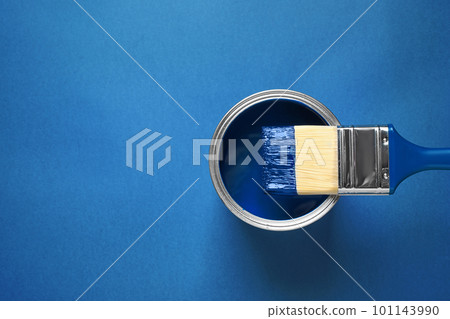 Can of paint and brush on bright background, top view with space for text. Color of the year 2020 (Classic blue) Can of paint and brush on bright background, top view with space for text. Color of the year 2020 (Classic blue) 101143990