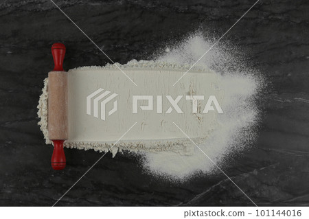 Flour and rolling pin on grey marble table, flat lay with space for text Flour and rolling pin on grey marble table, flat lay with space for text 101144016