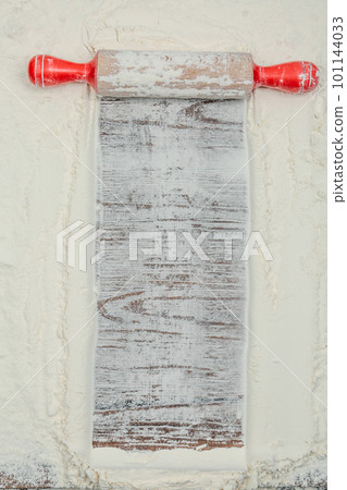 Flour and rolling pin on wooden table, top view. Space for text Flour and rolling pin on wooden table, top view. Space for text 101144033