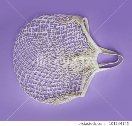 Empty white net bag on lilac background, top view Empty white net bag on lilac background, top view 101144145