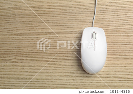 Wired computer mouse on wooden background, top view. Space for text 101144516