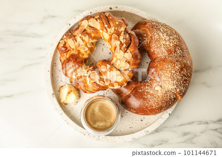 Fresh tasty pastries and coffee on white marble table, top view 101144671