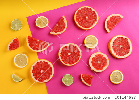 Flat lay composition with tasty ripe grapefruit slices on color background 101144688