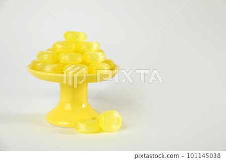 Tasty small lemon drops on white background 101145038