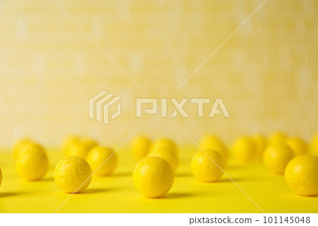 Delicious lemon chewing gums on yellow table 101145048