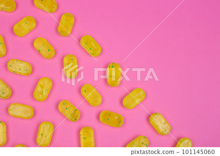 Many delicious lemon drops on pink background, flat lay Many delicious lemon drops on pink background, flat lay 101145060