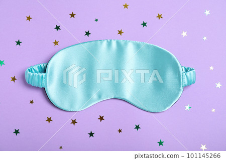 Sleeping mask and glitter on violet background, flat lay. Bedtime accessory 101145266