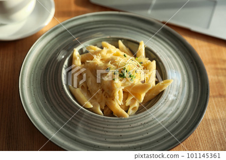 Tasty pasta with cheese on wooden table 101145361