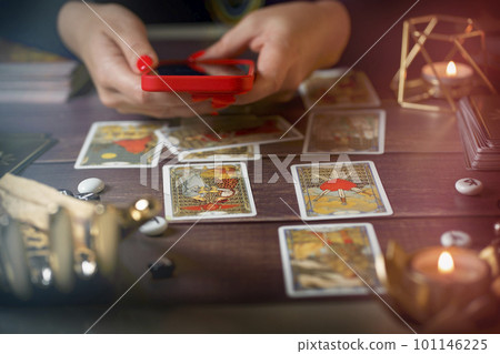 Tarot card reader arranges cards in a card spread. Fortune-telling concept Tarot card reader arranges cards in a card spread. Fortune-telling concept 101146225