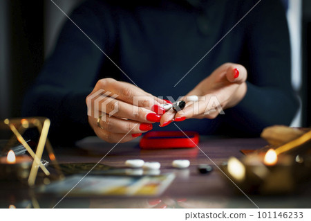 A fortune teller does online fortune telling on photos from a smartphone. A fortune teller does online fortune telling on photos from a smartphone. 101146233