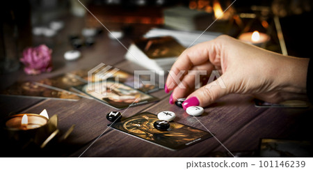 Tarot card reader arranges cards in a card spread. Fortune-telling concept Tarot card reader arranges cards in a card spread. Fortune-telling concept 101146239