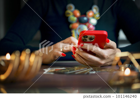Tarot card reader arranges cards in a card spread. Fortune-telling concept Tarot card reader arranges cards in a card spread. Fortune-telling concept 101146240