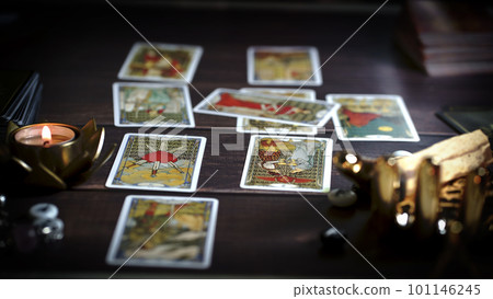 Tarot card reader arranges cards in a card spread. Fortune-telling concept Tarot card reader arranges cards in a card spread. Fortune-telling concept 101146245