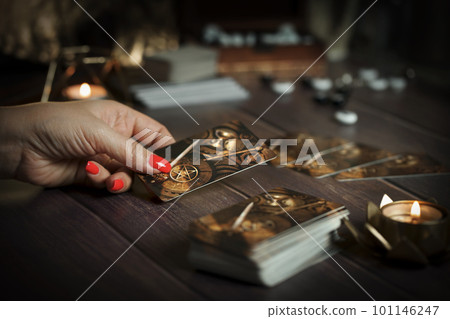 Tarot card reader arranges cards in a card spread. Fortune-telling concept  101146247