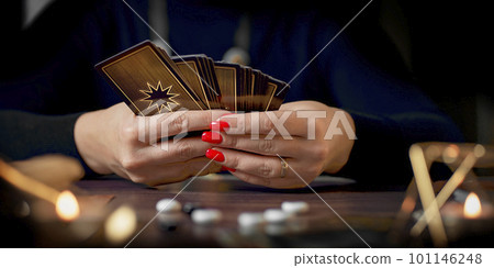 Blurred tarot cards on the table, esoteric concept, fortune telling predictions 101146248