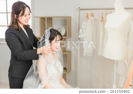 Bride and wedding planner woman preparing for bridal wedding ceremony Bride and wedding planner woman preparing for bridal wedding ceremony 101150402