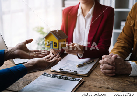home loan officer sending house model to client after signing agreement contract real estate with approved mortgage application form, concerning mortgage loan offer for and house insurance. home loan officer sending house model to client after signing agreement contract real estate with approved mortgage application form, concerning mortgage loan offer for and house insurance. 101152729