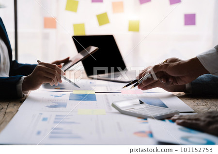 Teamwork process, Business team using a calculator to calculate the numbers of statistic business profits growth rate on documents graph data, desk in the office. 101152753