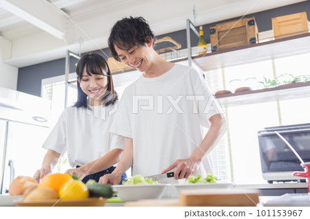 young couple cooking together 101153967