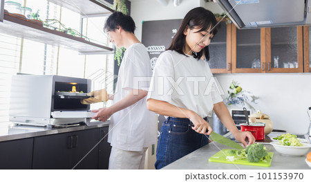 young couple cooking together 101153970