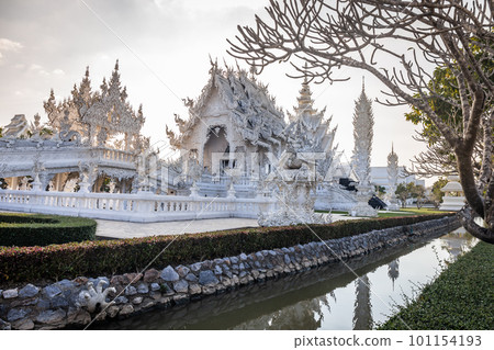 Beautiful and amazing white temple at Wat Rong Khun at sunset time Chiang Rai, Thailand It is a tourist destination. Landmark of Chiang Rai 101154193