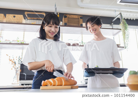 young couple cooking together 101154400