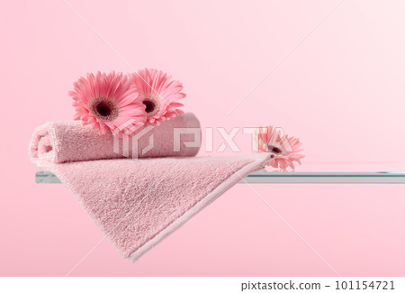 Spa composition with pink gerber and towels. 101154721