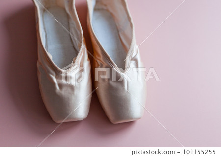 ballet slippers lying on pink background-elegant ballet shoes for dance top view ballet slippers lying on pink background-elegant ballet shoes for dance top view 101155255