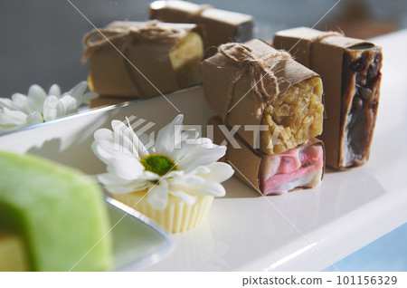 Still life with handmade organic soap bars, dry solid shampoo and hair conditioner with natural ingredients on a white surface against bathroom mirror background. Home spa, hygiene, skin and body care Still life with handmade organic soap bars, dry solid shampoo and hair conditioner with natural ingredients on a white surface against bathroom mirror background. Home spa, hygiene, skin and body care 101156329
