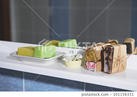 Still life composition with handmade natural organic soap bars, solid shampoos, hair conditioner and a spa scrub against the background of bathroom mirror. Hygiene, skin, hair and body care concept Still life composition with handmade natural organic soap bars, solid shampoos, hair conditioner and a spa scrub against the background of bathroom mirror. Hygiene, skin, hair and body care concept 101156331