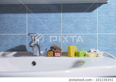 Still life with cold pressed organic ecologically friendly soap bars with natural ingredients on the bathroom washbasin. Natural eco-friendly cosmetics, home spa, body care, hygiene and beauty concept 101156341