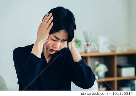 A young woman suffering from a headache 101156814