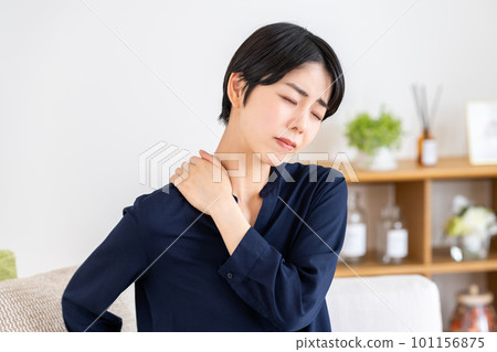 A woman suffering from stiff shoulders A woman suffering from stiff shoulders 101156875