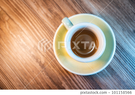 fresh tasty cup of espresso or americano coffee on the table in cafe 101158566