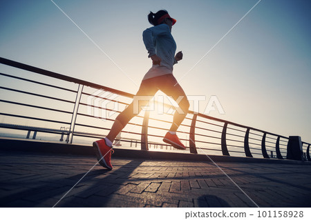 Fitness woman runner running on seaside bridge Fitness woman runner running on seaside bridge 101158928