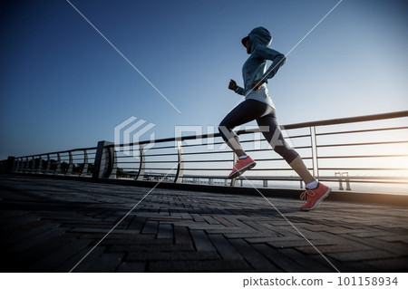 Fitness woman runner running on seaside bridge Fitness woman runner running on seaside bridge 101158934