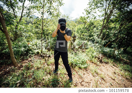 Woman photographer taking pictures in summer mountains Woman photographer taking pictures in summer mountains 101159578