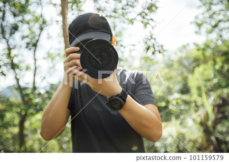 Woman photographer taking pictures in summer mountains Woman photographer taking pictures in summer mountains 101159579