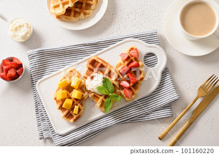 Tasty breakfast with croffles mango, strawberries. Croissant as waffle. 101160220