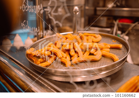 Fried churros churro typical spain sweet while after frying cooking, Barcelona, Spain Fried churros churro typical spain sweet while after frying cooking, Barcelona, Spain 101160662