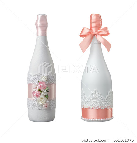 Two wedding champagne bottles decorated with rose flowers, lace and ribbon. Isolated on white. Two wedding champagne bottles decorated with rose flowers, lace and ribbon. Isolated on white. 101161370