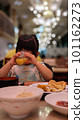 Child drinking juice on buffet 101162273
