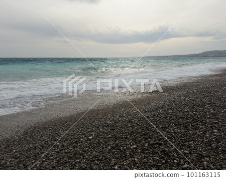Pebble beach of Nice, France with azure waves of mediterranean sea Pebble beach of Nice, France with azure waves of mediterranean sea 101163115