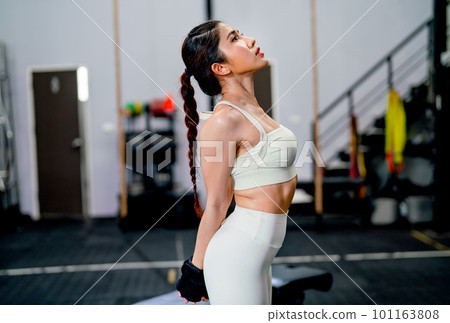 Asian woman with sportwear stand with stretching action in fitness gym and relax after exercise. 101163808