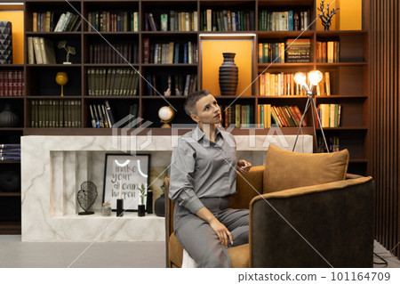 a businesswoman with a short haircut during a coffee break relaxes in the office 101164709