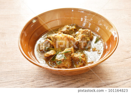 spicy fried pork bone with curry and basil leaf on bowl 101164823