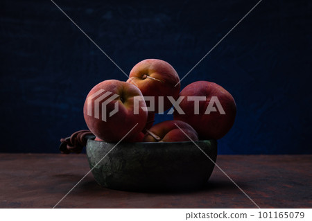 Still life with peaches. The plate is filled with peaches. Lots of peaches in the bowl. 101165079