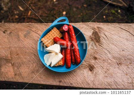 Sausages, cheese and cookies in a plate. Tourist snack in a plate. Snacks on hikes. Sausages, cheese and cookies in a plate. Tourist snack in a plate. Snacks on hikes. 101165137