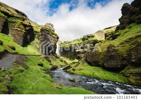 Kvernufoss waterfall flowing through the green valley in sunny day on summer at Iceland 101165401