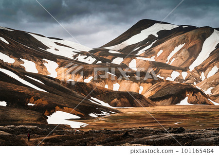 Scenery of majestic volcanic mountain range with snow covered in Fjallabak nature reserve, Icelandic Highlands at Landmannalaugar 101165484